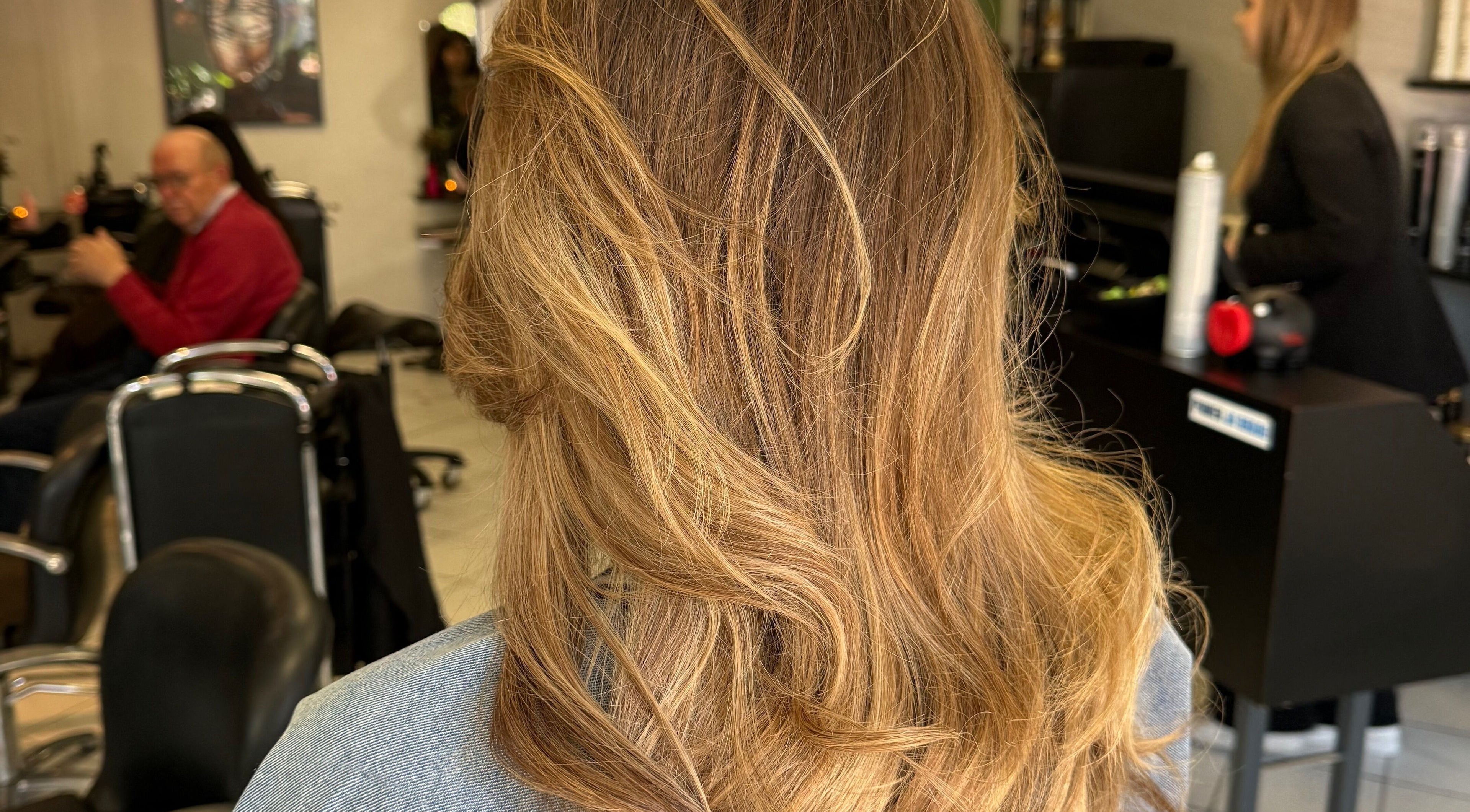 Stylish hair styling at vanDeelen, Randwijk, Gelderland, NL. Blonde waves professionally treated in salon.