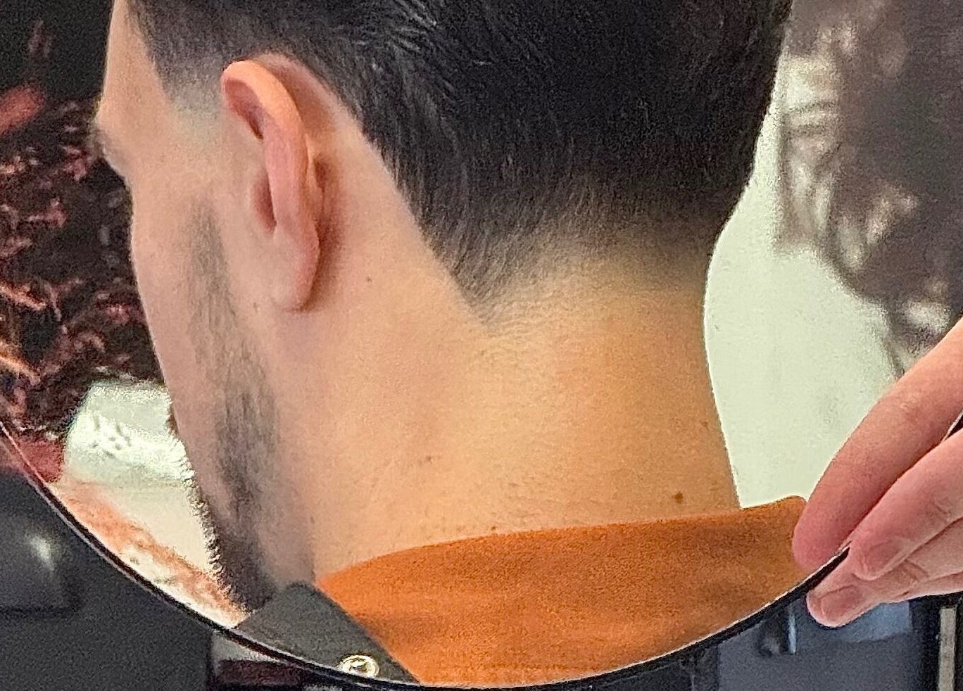 Sleek haircut reflection at vanDeelen, Randwijk, Gelderland, NL showcases expert styling.