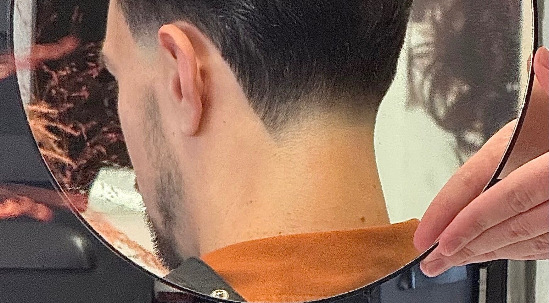 Sleek haircut reflection at vanDeelen, Randwijk, Gelderland, NL showcases expert styling.