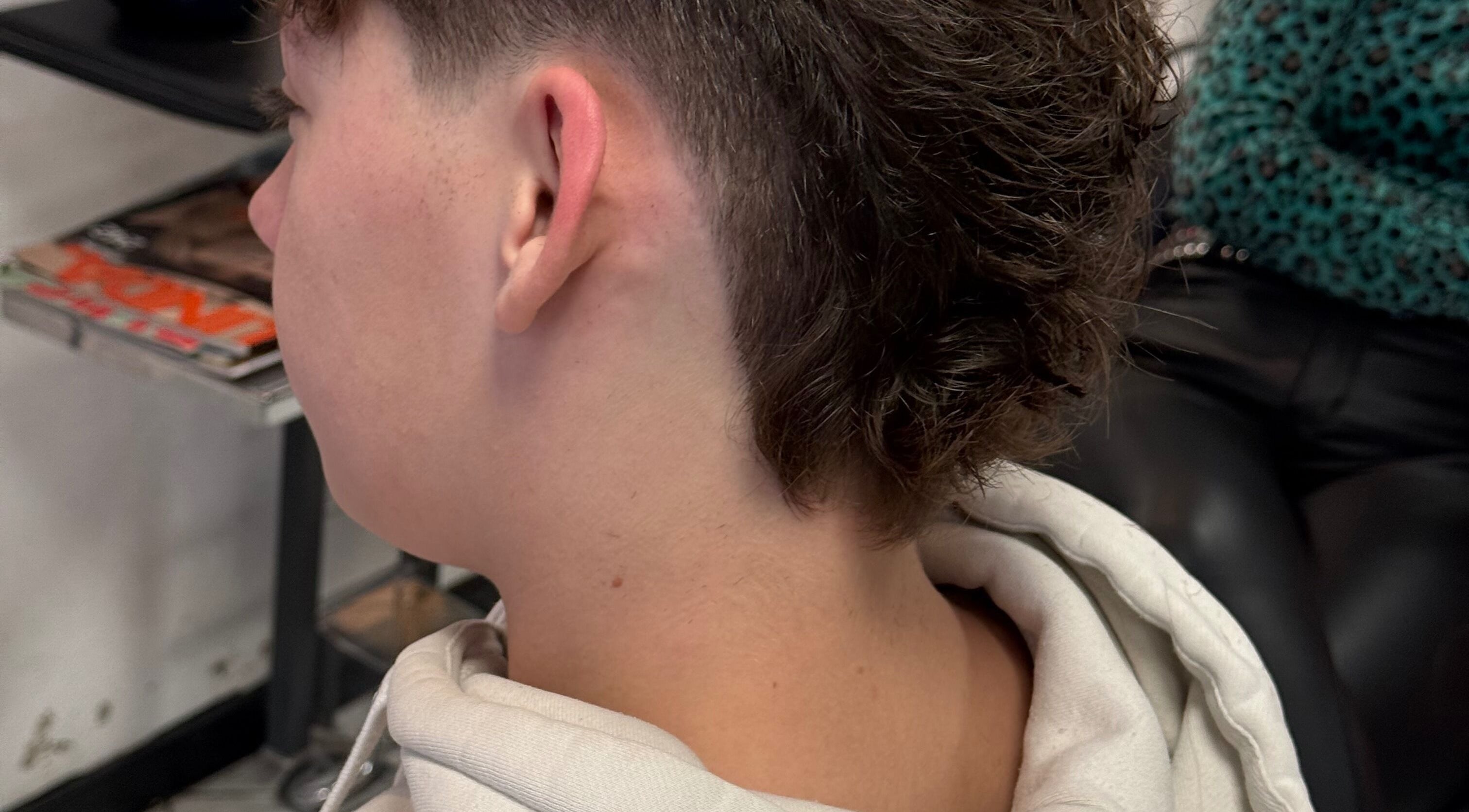 Stylish mullet haircut at vanDeelen, Randwijk, Gelderland, NL, showcasing a trendy and modern look.