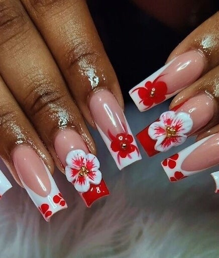 Artistic floral nail design at House Of Sky Beauty Bar in San Fernando, TT, showcasing vibrant red accents.
