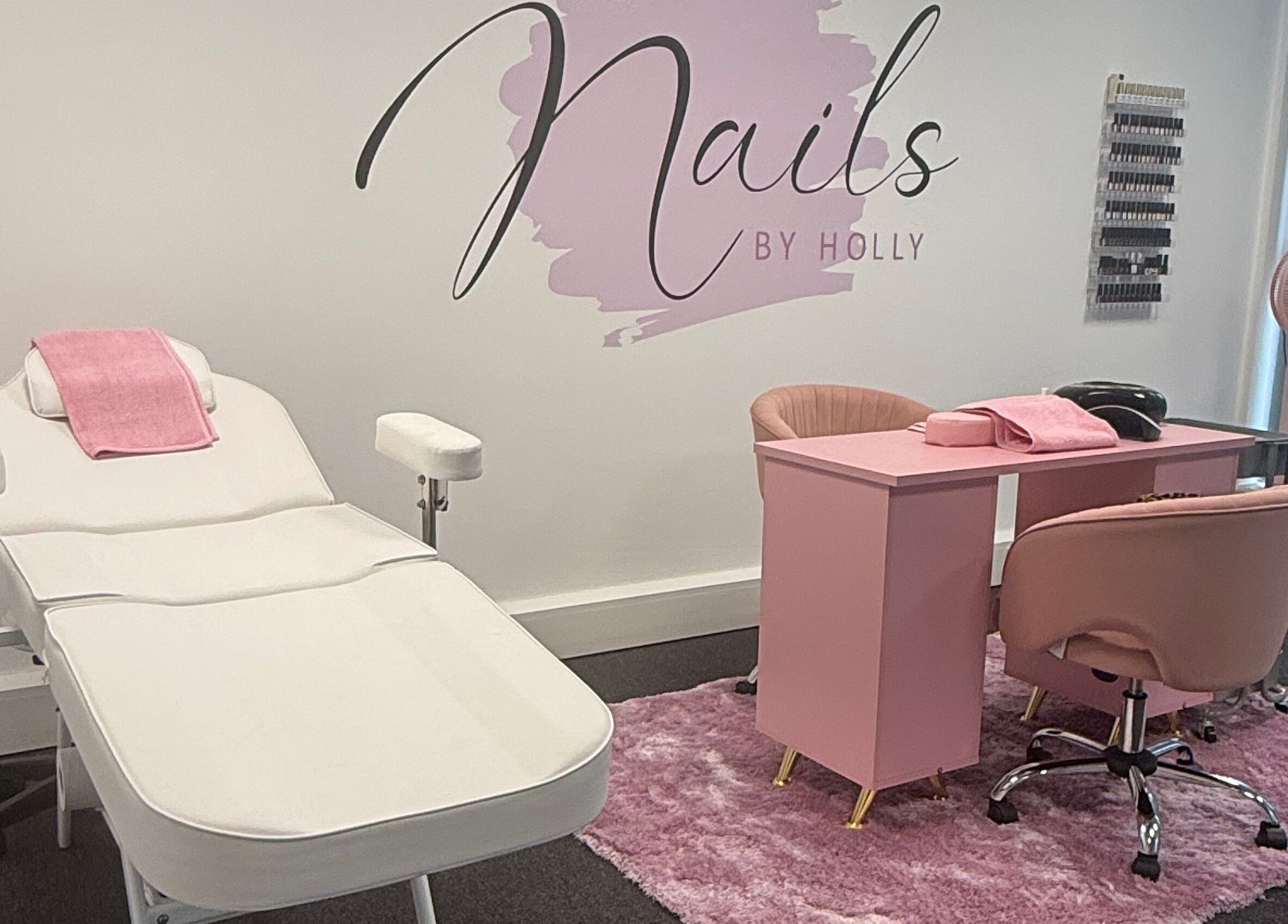 Nails By Holly salon interior with pink decor in Great Blakenham, England, GB showcasing a nail station and chair.