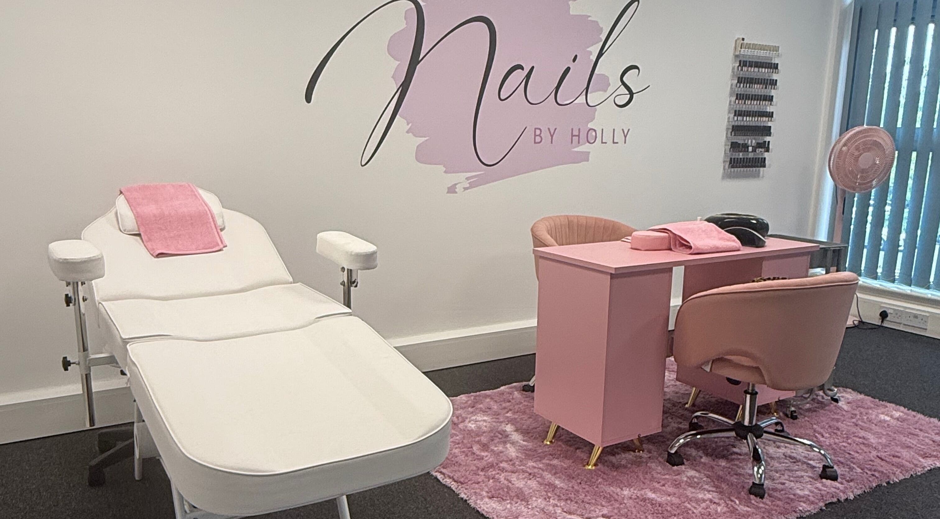 Nails By Holly salon interior with pink decor in Great Blakenham, England, GB showcasing a nail station and chair.