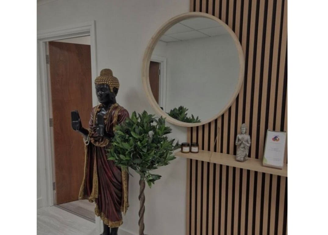 Sledge Sport Therapy entrance in Bristol, England, GB featuring a serene Buddha statue and circular mirror.