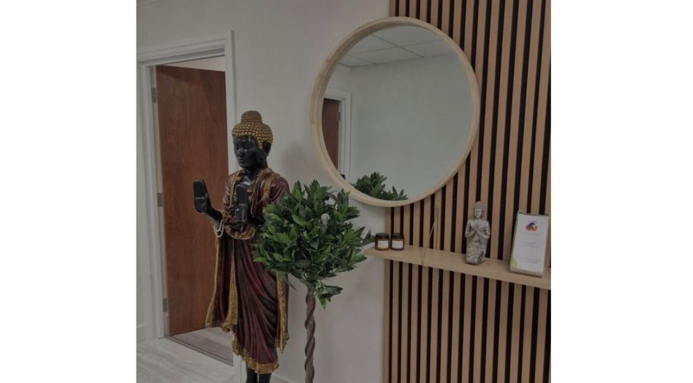 Sledge Sport Therapy entrance in Bristol, England, GB featuring a serene Buddha statue and circular mirror.
