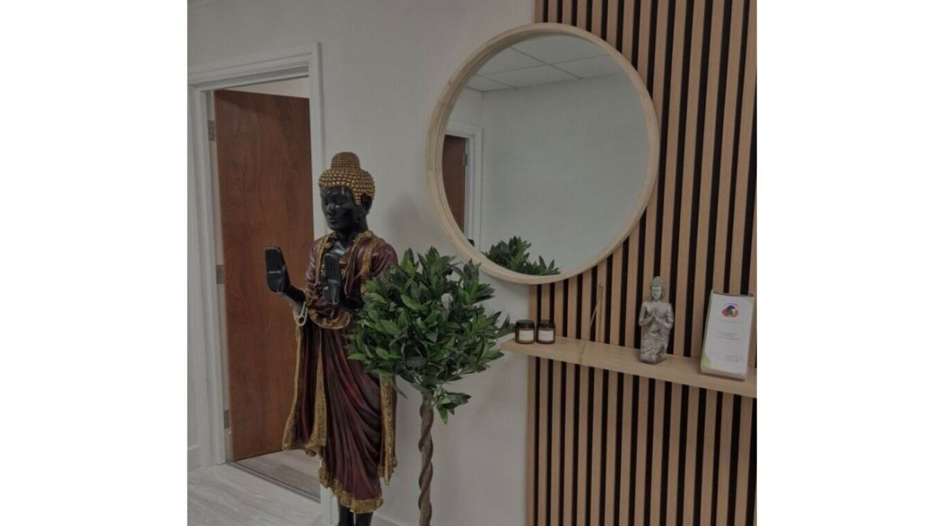 Sledge Sport Therapy entrance in Bristol, England, GB featuring a serene Buddha statue and circular mirror.