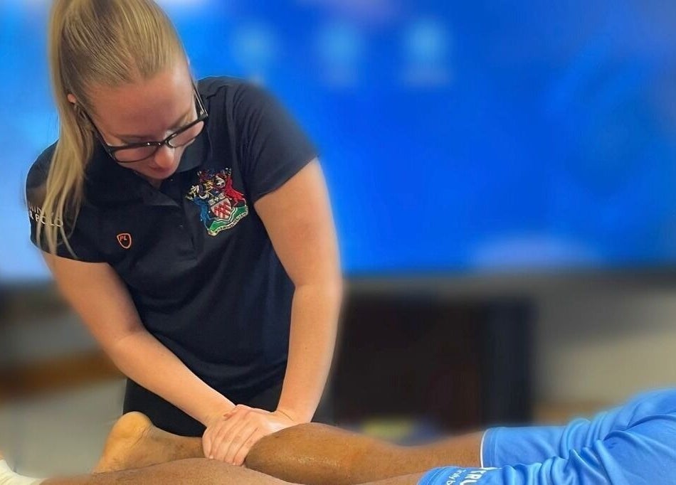 Therapist at Sledge Sport Therapy in Bristol, England, GB, providing leg massage.