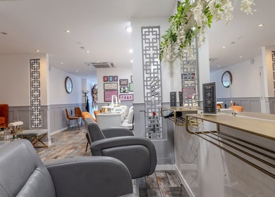 Stylish interior of Hair by Bon in Bromley, England, GB, featuring modern decor and sleek chairs.