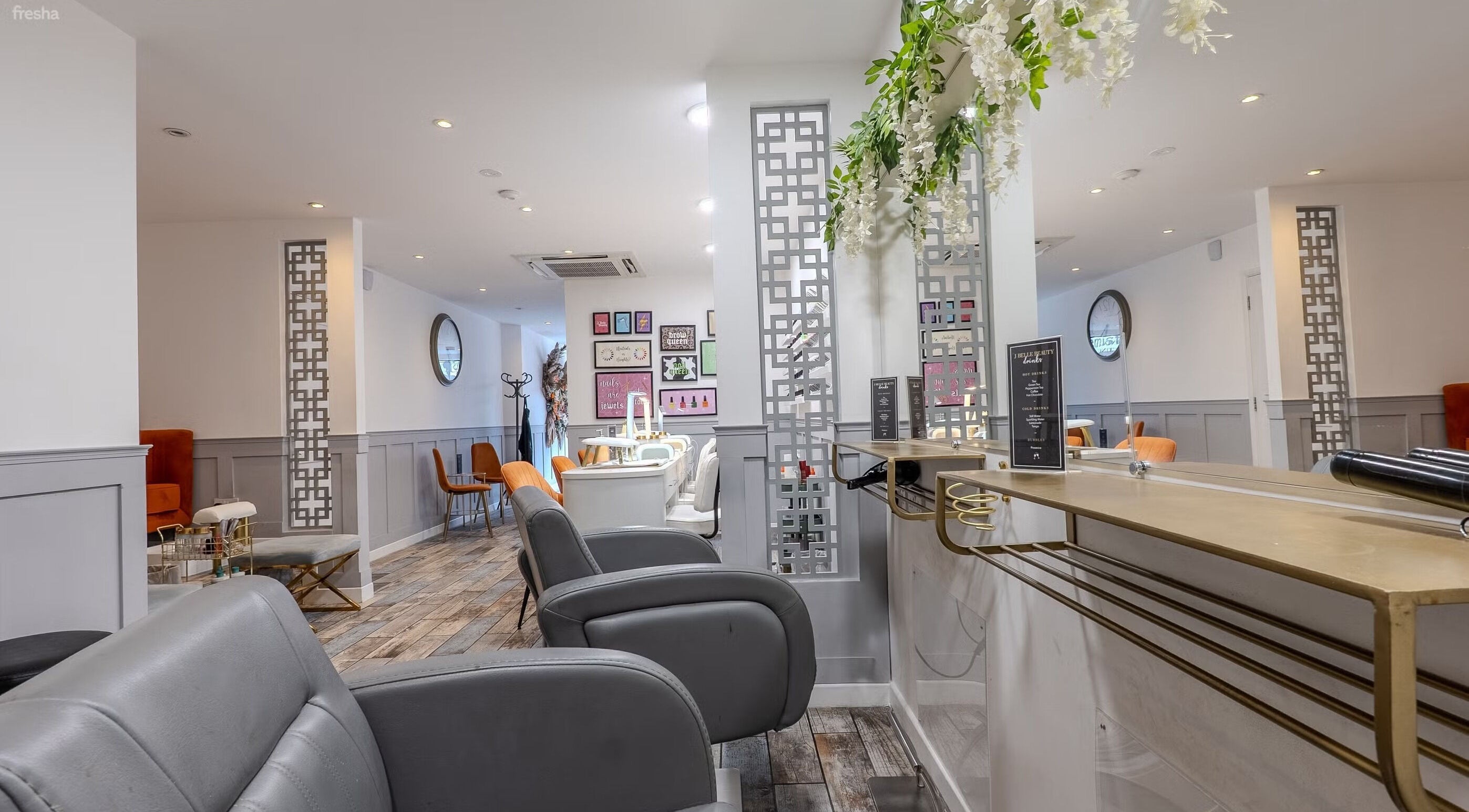 Stylish interior of Hair by Bon in Bromley, England, GB, featuring modern decor and sleek chairs.