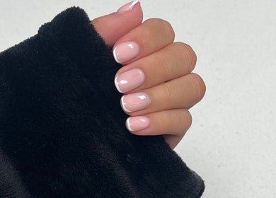 Glossed by Ell French manicure in Oldbury, England, GB showcasing elegant and glossy nails.