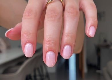 Soft pink manicure at Glossed by Ell, Oldbury, England, GB with a gold ring accent.