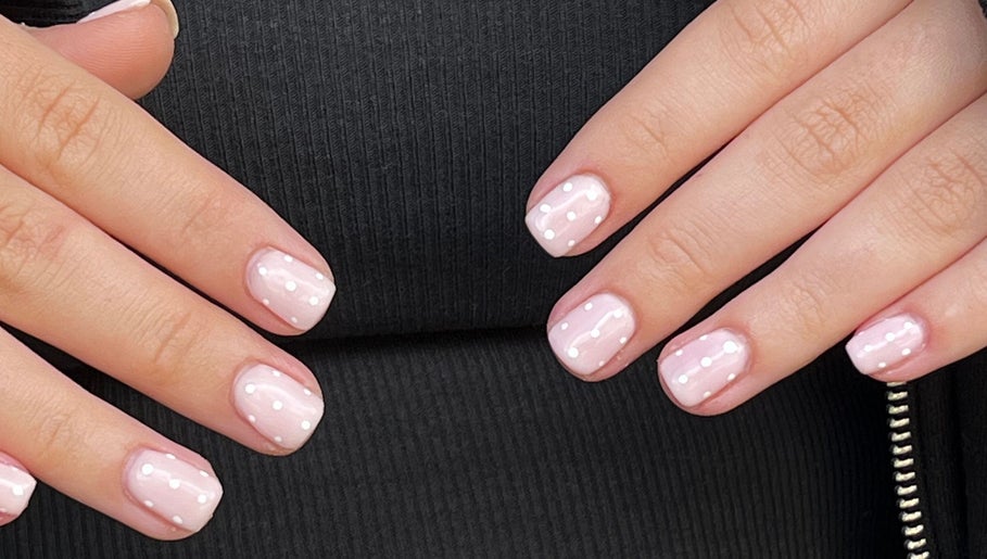 Glossed by Ell nail art featuring soft pink polish with white dots, located in Oldbury, England, GB.
