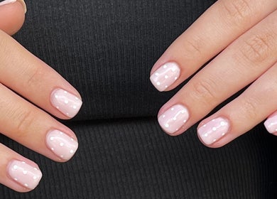 Glossed by Ell nail art featuring soft pink polish with white dots, located in Oldbury, England, GB.