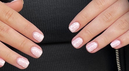 Glossed by Ell nail art featuring soft pink polish with white dots, located in Oldbury, England, GB.