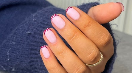Stylish dotted French manicure at Glossed by Ell, Oldbury, England, GB showcasing elegant nail art design.