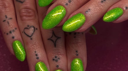 Vibrant neon green nails with delicate tattoos at Cured By Jess, Sandbach, England, GB.