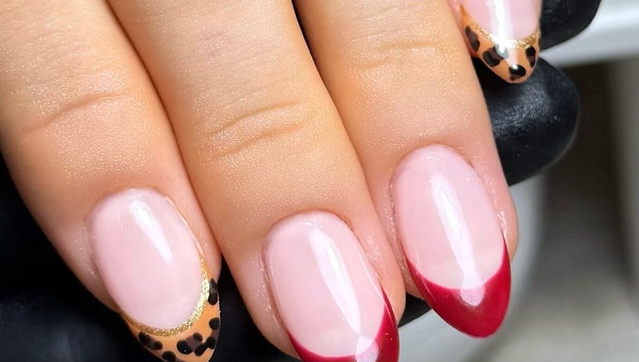 Elegant nail art with red and leopard tips at Cured By Jess, Sandbach, England, GB.