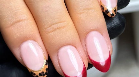 Elegant nail art with red and leopard tips at Cured By Jess, Sandbach, England, GB.