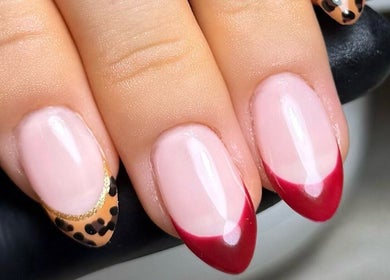 Elegant nail art at Cured By Jess, Sandbach, England, GB, featuring red and animal print designs.