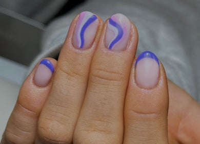 Unique vibrant nail art at Cured By Jess, Sandbach, England, GB, featuring blue and pink swirl designs.