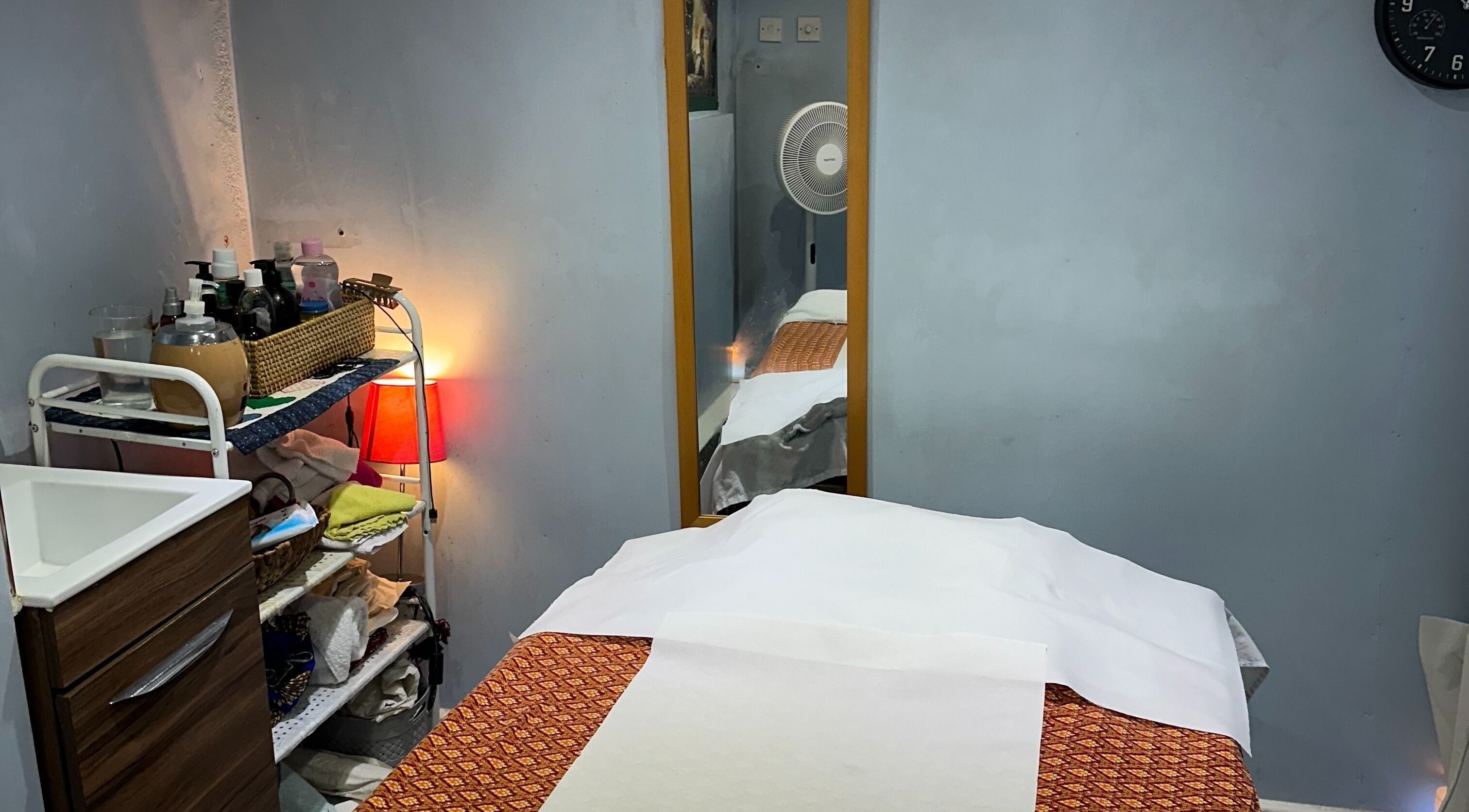 Relaxing treatment room at TA Thai Massage, London, England, GB, showcasing a cozy massage table setup.