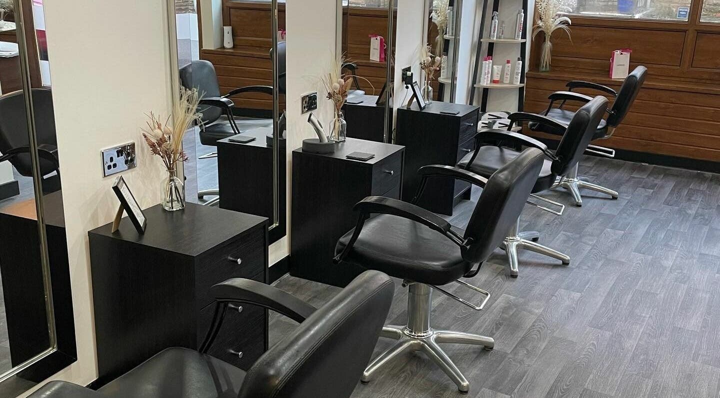 Modern styling area at Palmowski Hair Design in Wath upon Dearne, England, GB with sleek chairs and mirrors.