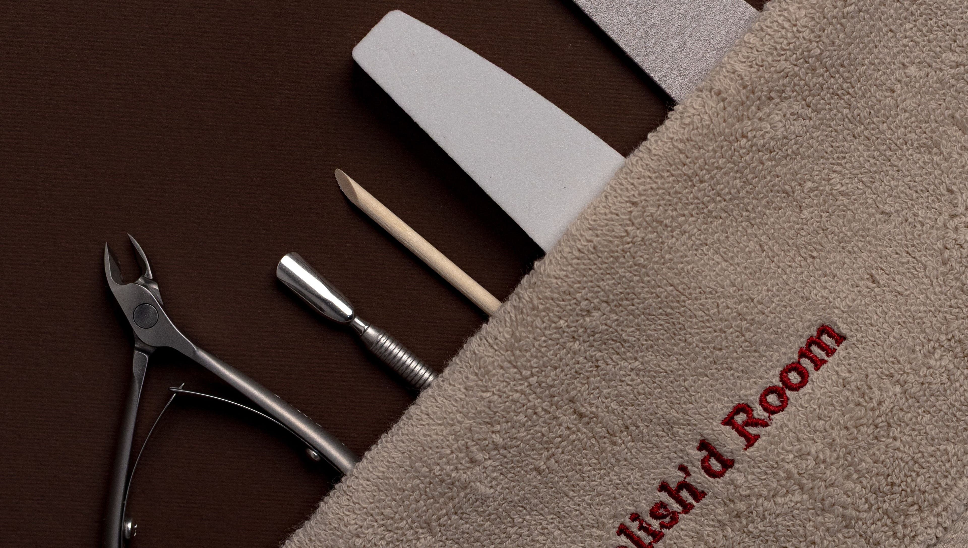 Nail care tools at The Polish'd Room in Casablanca, Casablanca-settat, MA displayed on a brown surface.