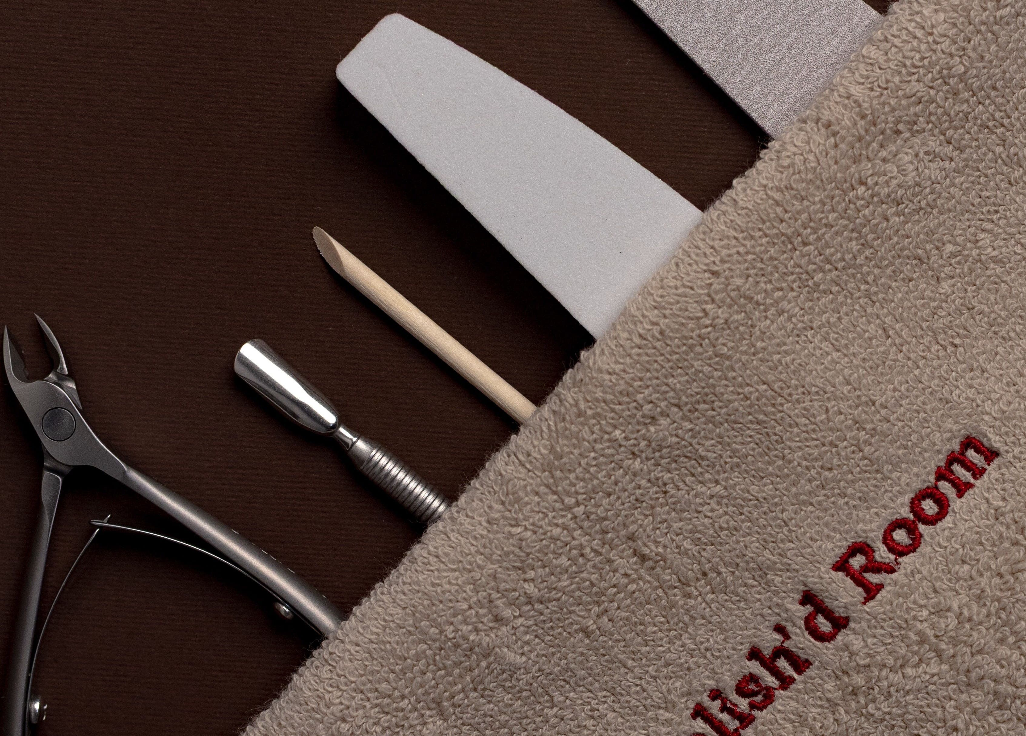 Nail care tools at The Polish'd Room in Casablanca, Casablanca-settat, MA displayed on a brown surface.
