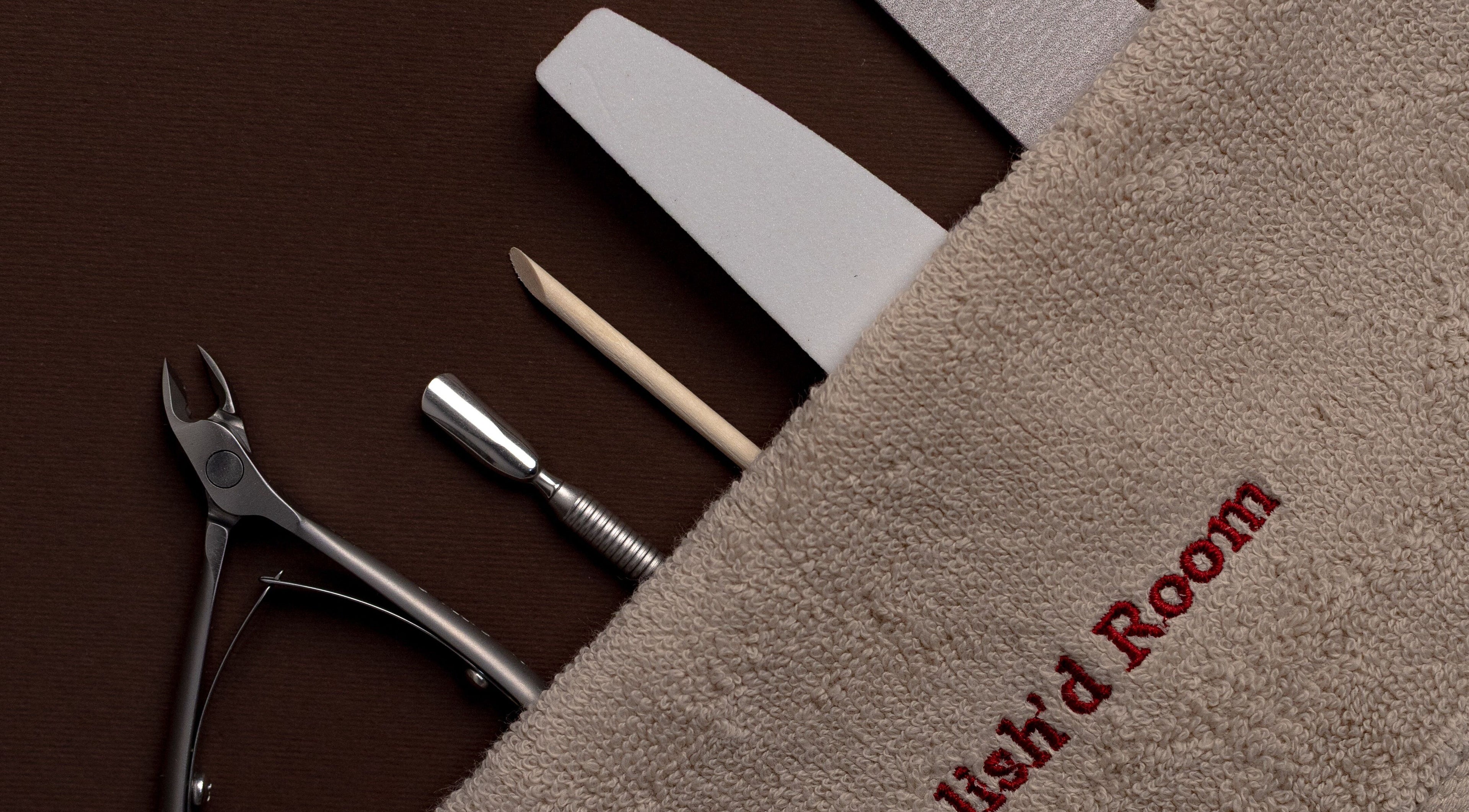 Nail care tools at The Polish'd Room in Casablanca, Casablanca-settat, MA displayed on a brown surface.