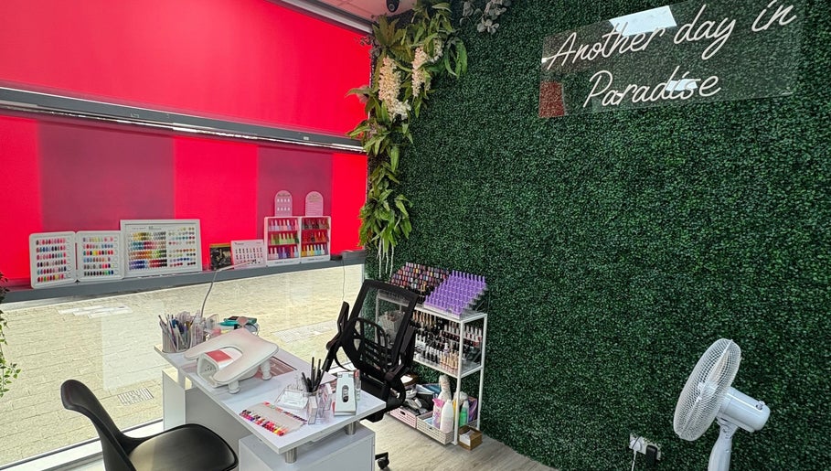 At Your Fingertips nail studio in Tralee, County Kerry, IE with lush greenery and vibrant nail polish display.