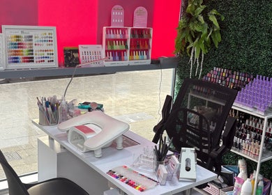 Manicure station at At Your Fingertips, Tralee, County Kerry, IE showcasing vibrant nail polish selection.