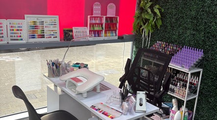 Manicure station at At Your Fingertips, Tralee, County Kerry, IE showcasing vibrant nail polish selection.
