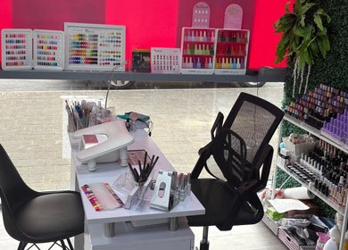 At Your Fingertips nail station with colorful polish in Tralee, County Kerry, IE offering vibrant selections.