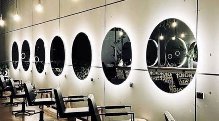 Modern salon mirrors and chairs at Hair By Flute, Southport, Queensland, AU showcasing stylish ambiance.