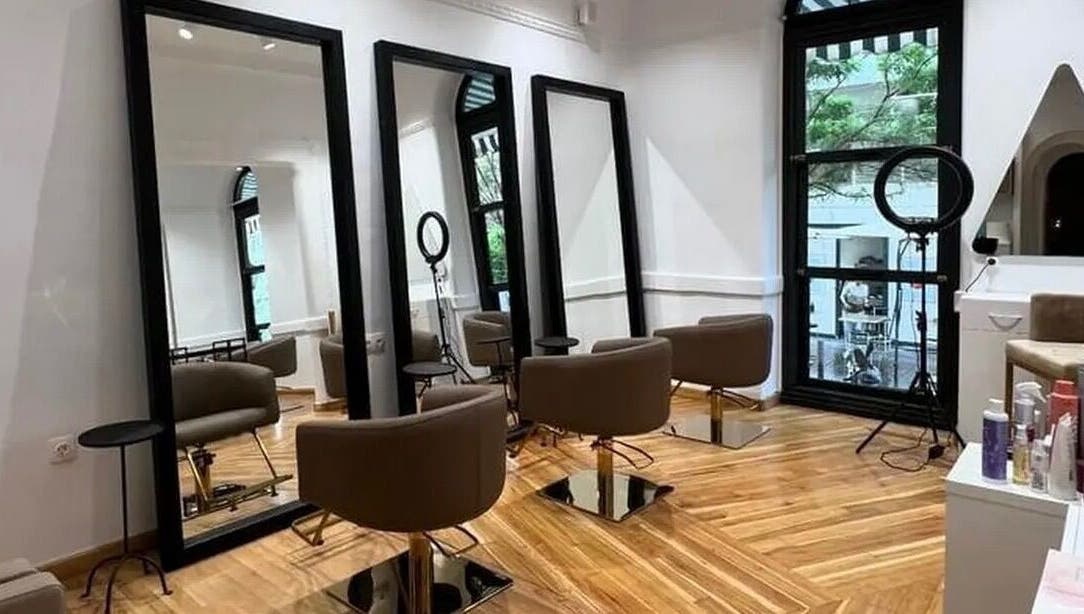 Κομψό εσωτερικό του B Exclusive στη Θεσσαλονίκη, GR με καθρέφτες και καθίσματα.