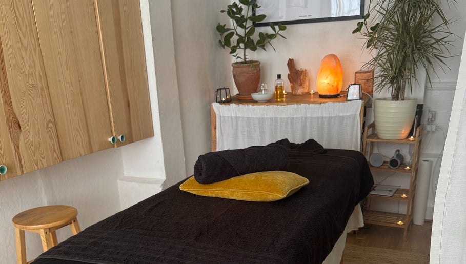 Relaxing massage room at Slow Down, Brighton And Hove, England, GB with soft lighting and cozy decor.