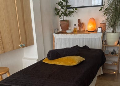 Relaxing massage room at Slow Down, Brighton And Hove, England, GB with soft lighting and cozy decor.