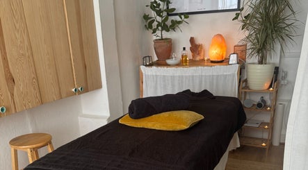 Relaxing massage room at Slow Down, Brighton And Hove, England, GB with soft lighting and cozy decor.