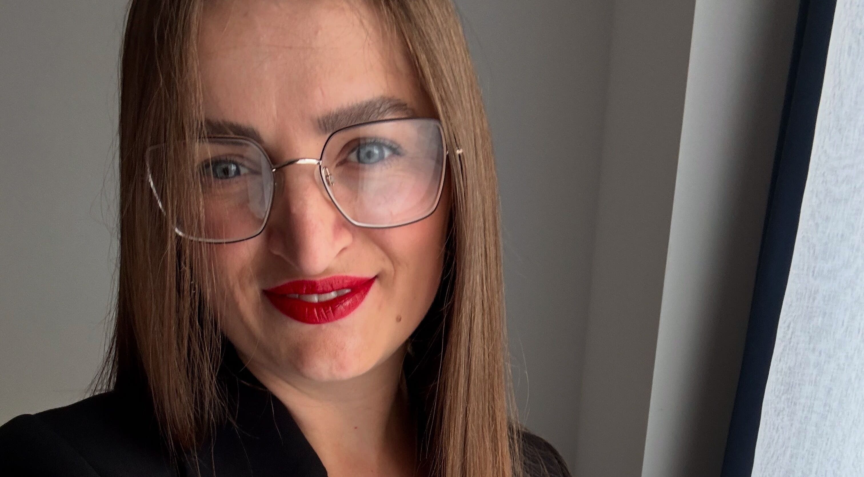 Professional at ZInailSTUDIO in Milton Keynes, England, showcasing chic style with glasses.