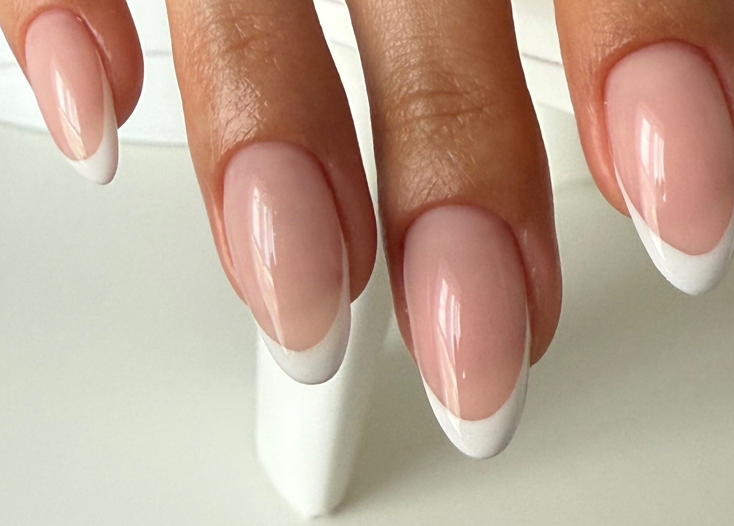 Sophisticated French manicure at ZInailSTUDIO, Milton Keynes, England, GB. Perfectly polished nails.
