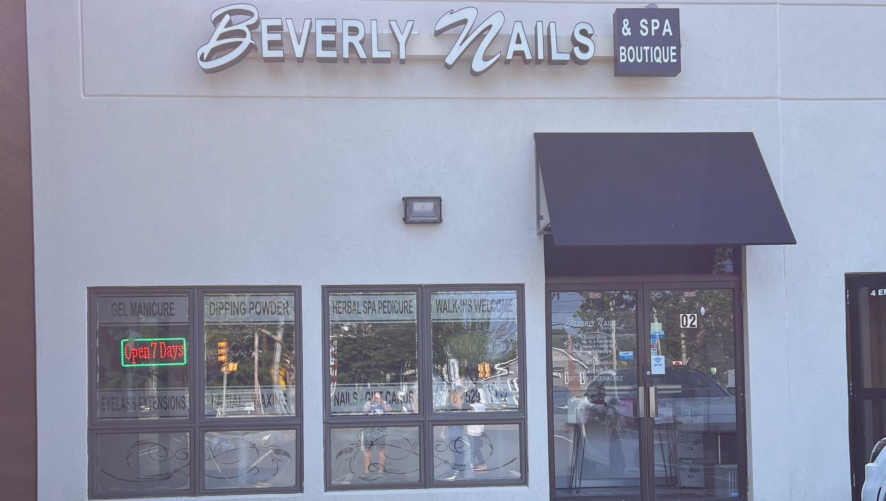 Facade of Beverly Nails and Spa Boutique in Beverly, Massachusetts, US featuring signage and welcoming windows.