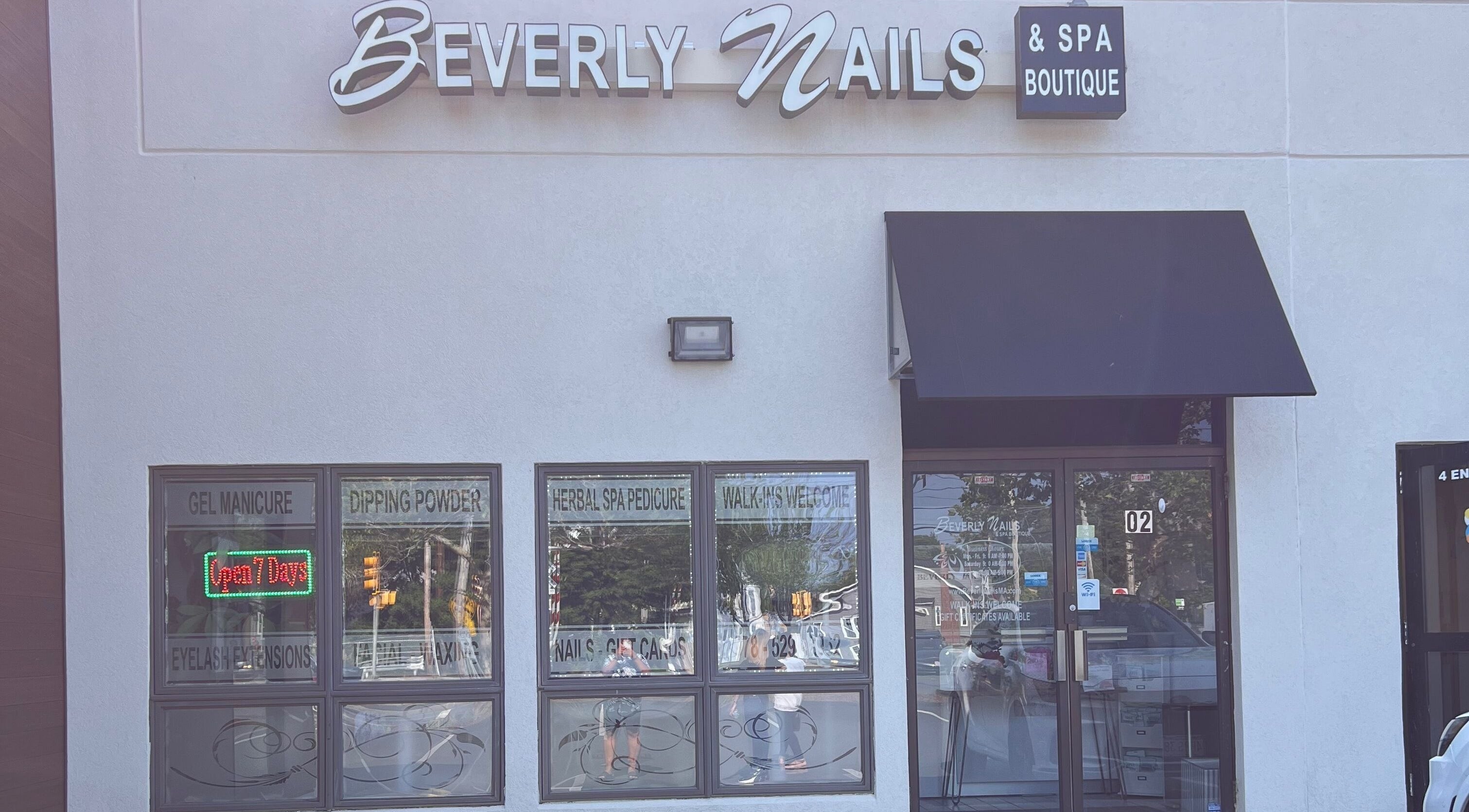 Facade of Beverly Nails and Spa Boutique in Beverly, Massachusetts, US featuring signage and welcoming windows.