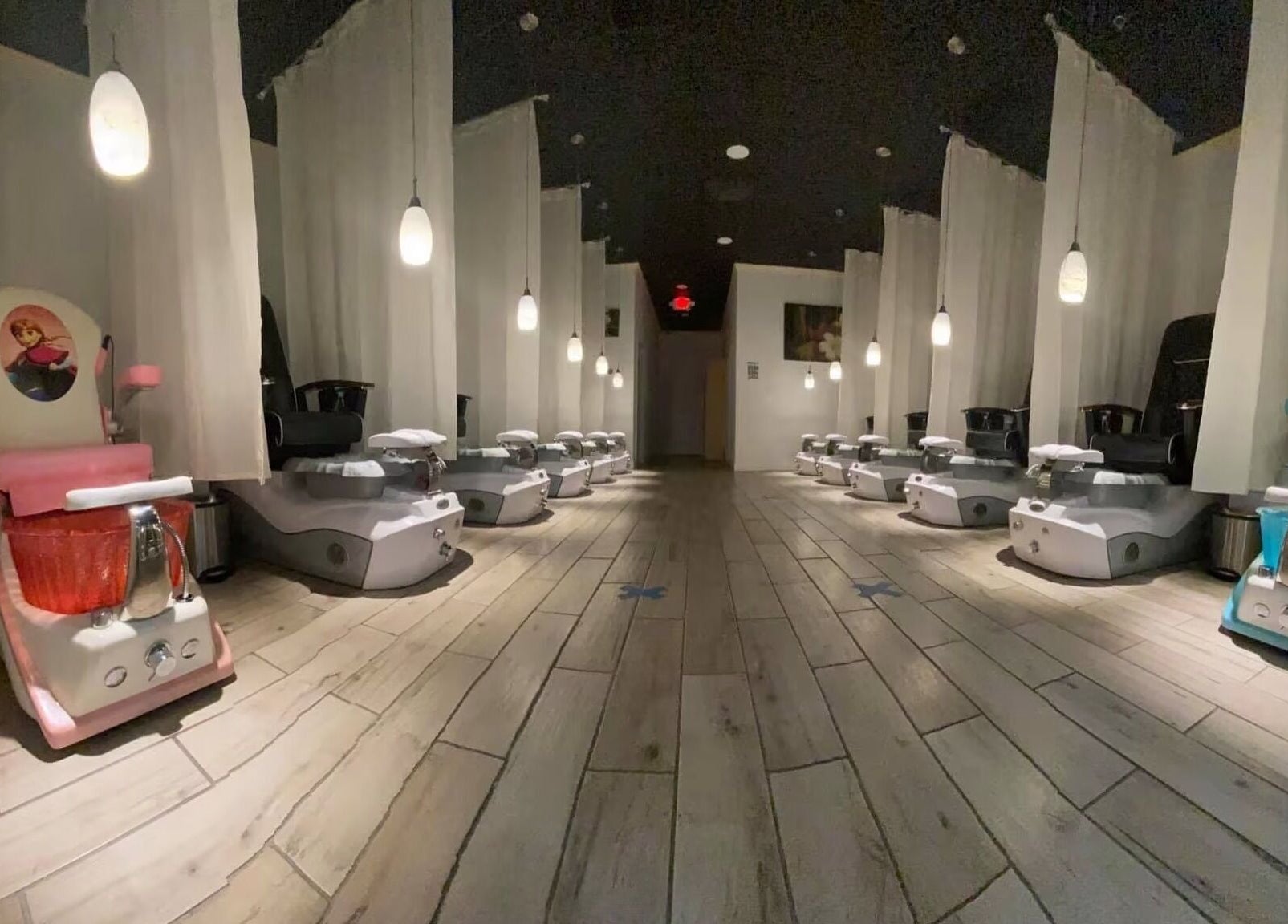 Luxurious pedicure chairs at Beverly Nails and Spa Boutique in Beverly, Massachusetts, US, under soft lighting.