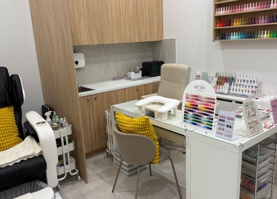 Naily atelier's cozy nail station in West Ryde, New South Wales, AU showcasing vibrant polishes and plush seating.