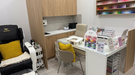 Naily atelier's cozy nail station in West Ryde, New South Wales, AU showcasing vibrant polishes and plush seating.