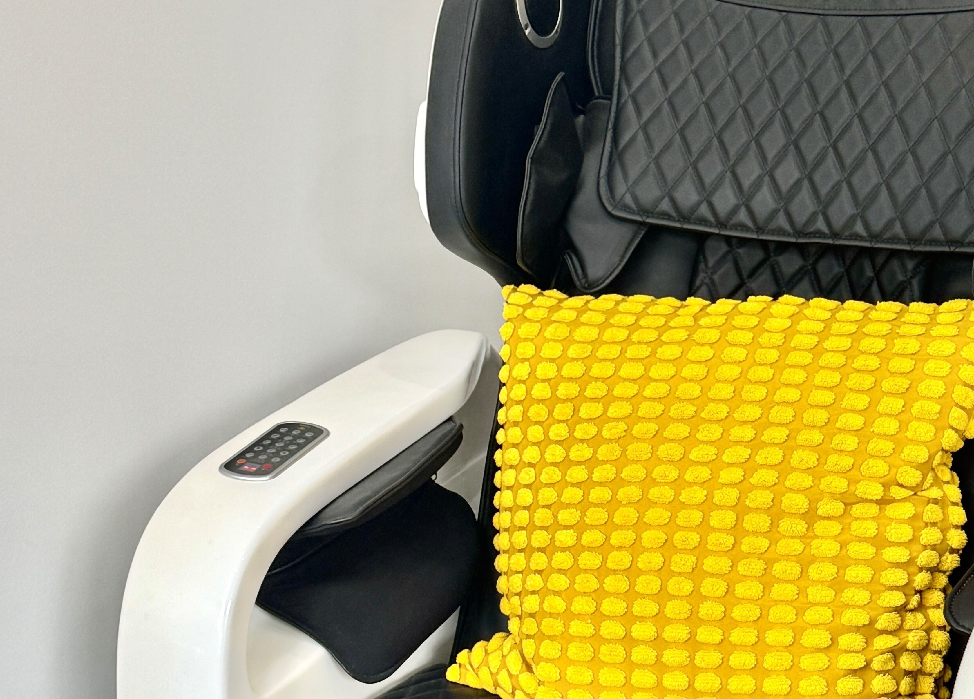 Cozy massage chair with yellow pillow at Naily Atelier, West Ryde, New South Wales, AU.
