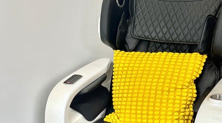 Cozy massage chair with yellow pillow at Naily Atelier, West Ryde, New South Wales, AU.