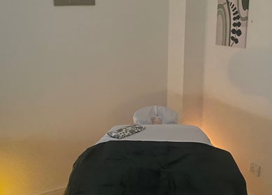 Cozy massage room at Massage therapies by Jess, Chippenham, England, GB with a soft-lit massage table.