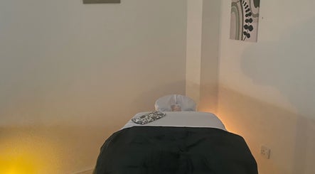 Cozy massage room at Massage therapies by Jess, Chippenham, England, GB with a soft-lit massage table.