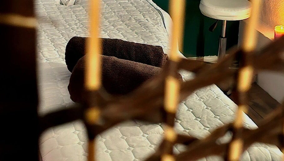 Relaxing massage bed at Healing Touch, Belfast, Northern Ireland featuring cozy brown towels and soothing ambiance.